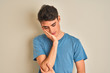 © Krakenimages.com - Teenager boy wearing casual t-shirt standing over isolated background thinking looking tired and bored with depression problems with crossed arms.
