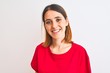 © Krakenimages.com - Beautiful redhead woman wearing casual red t-shirt over isolated background with a happy and cool smile on face. Lucky person.