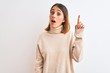 © Krakenimages.com - Beautiful redhead woman wearing winter turtleneck sweater over isolated background pointing finger up with successful idea. Exited and happy. Number one.