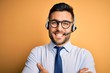 © Krakenimages.com - Young business operator man wearing customer service headset from call center happy face smiling with crossed arms looking at the camera. Positive person.