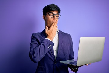 Sticker - Young handsome business man wearing glasses working using laptop over purple background cover mouth with hand shocked with shame for mistake, expression of fear, scared in silence, secret concept