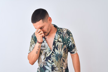 Poster - Young handsome man wearing Hawaiian summer shirt over isolated background tired rubbing nose and eyes feeling fatigue and headache. Stress and frustration concept.