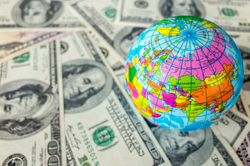 Globe on a pile of dollars planet earth