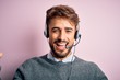 © Krakenimages.com - Young call center agent man with beard wearing headset over isolated pink background celebrating surprised and amazed for success with arms raised and open eyes. Winner concept.
