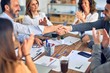 © Krakenimages.com - Group of business workers smiling happy and confident. Working together with smile on face shaking hands at the office