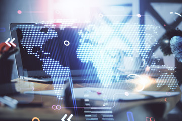 multi exposure of table with computer and world map hologram. international data network concept.