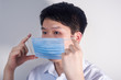 © Steve - A man is wearing a disposable surgical mask