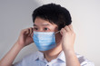 © Steve - A man is wearing a disposable surgical mask