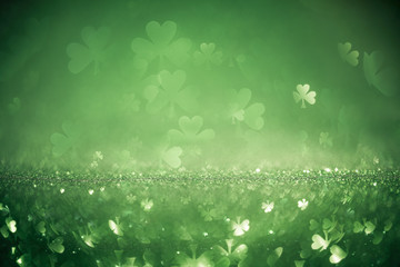 green st patricks day background with sparkling shamrock shapes