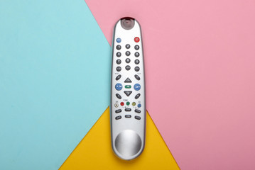 Tv remote control on a pastel colored background. Top view