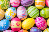 Fototapeta Tęcza - Happy Easter with colorful eggs at paintbrush for do it yourself on the grass with close up from top view
