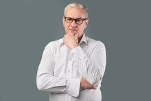 Senior Pensive Man Portrait On Gray Background