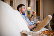© Yakobchuk Olena - Bachelor enjoying unhealthy meal at home stock photo