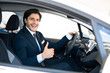 © Prostock-studio - Businessman Buying Car Gesturing Thumbs-Up In Driver's Seat