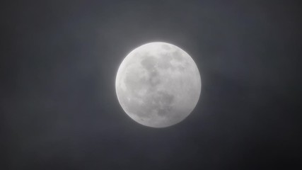 Wall Mural - full moon moving between clouds
