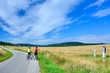 © Jurek Adamski - Cyclist taking pictures with smart phone.  Man in bike helmet taking photo of roadside shrine. Outdoor activity in Low Beskids, Poland.