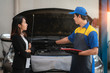A man mechanic and woman customer discussing repairs