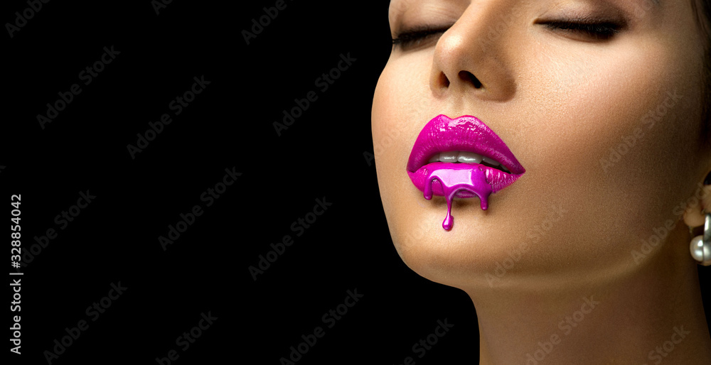 Pink Lipstick dripping. Paint drops on red lips, lipgloss dripping from sexy lips, Purple liquid drops on beautiful model girl's mouth, creative abstract make-up. Beauty woman face makeup close up - obrazy, fototapety, plakaty 
