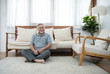 © mkitina4 - elder man sit on floor with happy in living room