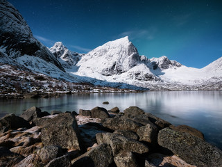 Canvas Print - Mountains and reflections on water at night. Winter landscape. The sky with stars and clouds in motion. Nature as a background. Norway - travel