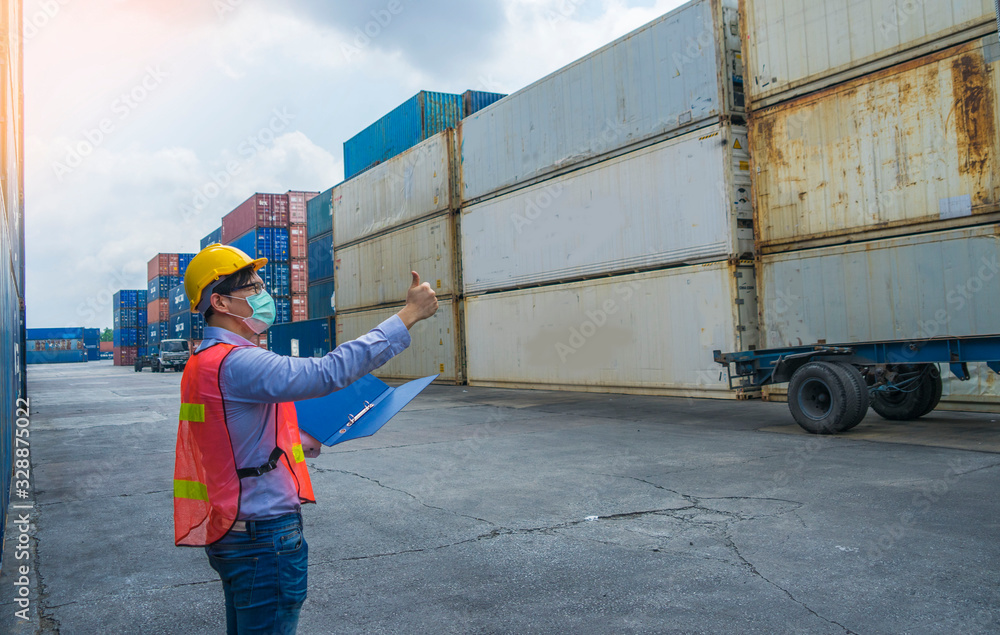 Engineer wearing a helmet standing cargo at the container yard and ...