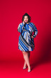 © staras - Plus size model in blue dress, fat sexy woman on red background