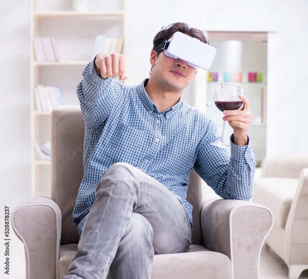 Young man drinking wine at home - obrazy, fototapety, plakaty 
