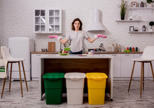Young Girl Sorting Garbage At The Kitchen. Concept Of Recycling. Zero Waste