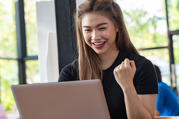 Wall Mural - Beautiful Attractive Asian woman working with computer laptop and thinking to get ideas and requirement in Business startup feeling so happiness,Business Startup Concept