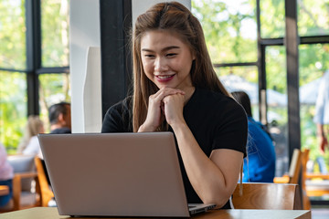 Wall Mural - Beautiful Attractive Asian woman working with computer laptop and thinking to get ideas and requirement in Business startup feeling so happiness,Business Startup Concept