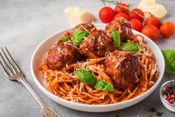 Wall Mural - pasta spaghetti with meatballs, tomato sauce, parmesan cheese and basil in a plate with fork. italian food