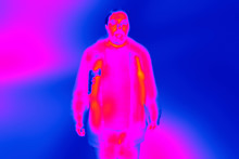 Blurred Image Obtained From Infrared Thermal Camera During Security Check. Suspicious Passenger With Guns.