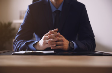 Wall Mural - Male lawyer at table in office, closeup