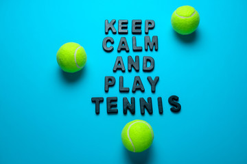 top view flat lay tennis balls and inscription keep calm and play tennis  on a bright blue background
