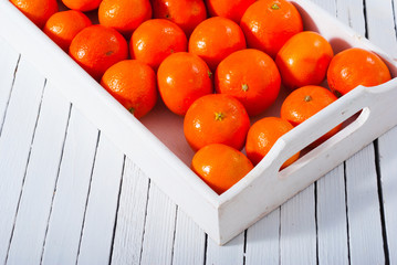 Wall Mural - tangerines on white wooden tray