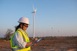 © reewungjunerr - women engineer working and holding the report at wind turbine farm Power Generator Station on mountain,Thailand people