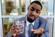 © Carlos David - Portrait of a sick young man in business suit taking a medicine pill with water