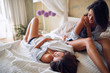 young lesbians talking on bed in bedroom. female, lesbian concept