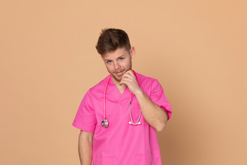 African doctor wearing a pink uniform on a yellow background