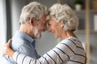 © fizkes - Happy mature 50s couple embrace touch foreheads look in the eyes show love and care at home, smiling elderly 60s husband and wife hug cuddle share close tender romantic moment together