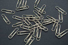 Heap Of Paper Clips Closeup Stationery On Black Clolor Background