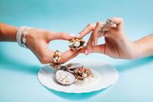 Beautiful Woman Hands With Pink Manicure Holding Plate With Pearls And Sea Shells, Luxury Jewelry Concept