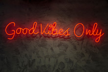 Neon With The Word Good Vibes Only, On Wall Texture.