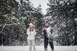 © Andrii - Couple playing with snow in the forest