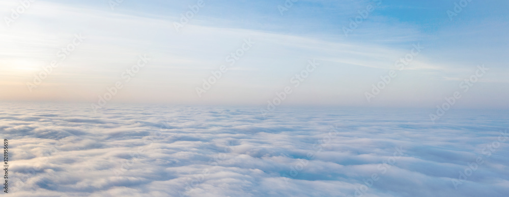 Yellow and blue dawn over clouds, concept, travel and leisure. - obrazy, fototapety, plakaty 