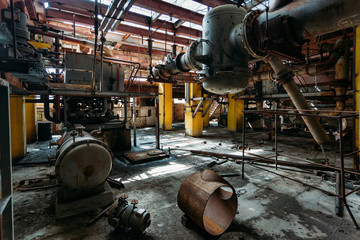 Sticker - Old rusty Industrial tanks connected by pipes connected with valves in abandoned chemical factory