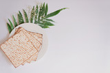 Fototapeta Łazienka - Passover background with matzoh and spring flower ranunculus. Top view with copy space. Happy Passover Spring Festive season greeting card. Jewish holidays arrangement