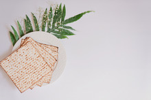 Passover Background With Matzoh And Spring Flower Ranunculus. Top View With Copy Space. Happy Passover Spring Festive Season Greeting Card. Jewish Holidays Arrangement
