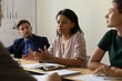 © fizkes - Diverse multiracial colleagues sit at meeting in office brainstorm consider ideas together, multiethnic coworkers businesspeople cooperate discuss financial project at briefing, collaboration concept