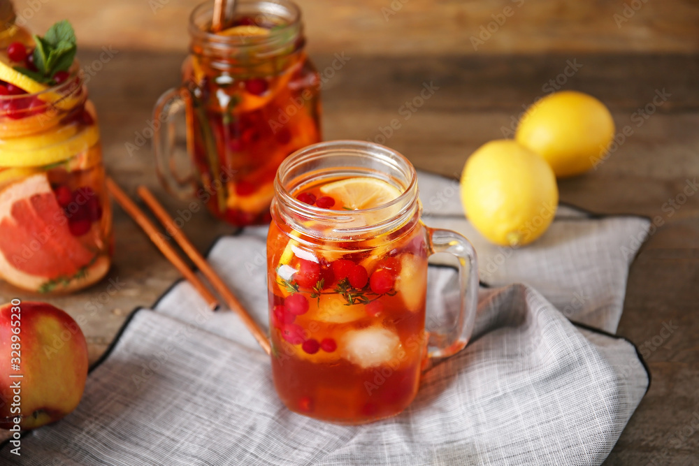 Mason jar of cold tea on wooden table
